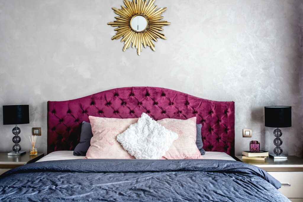 Luxurious bedroom interior with grey bedding and modern furniture. Bed details